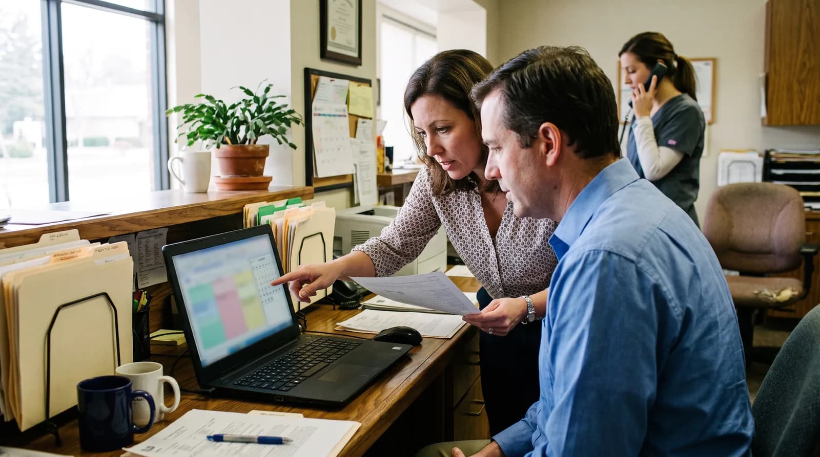 Dentist reviewing a business associate agreement with an AI receptionist vendor before signing