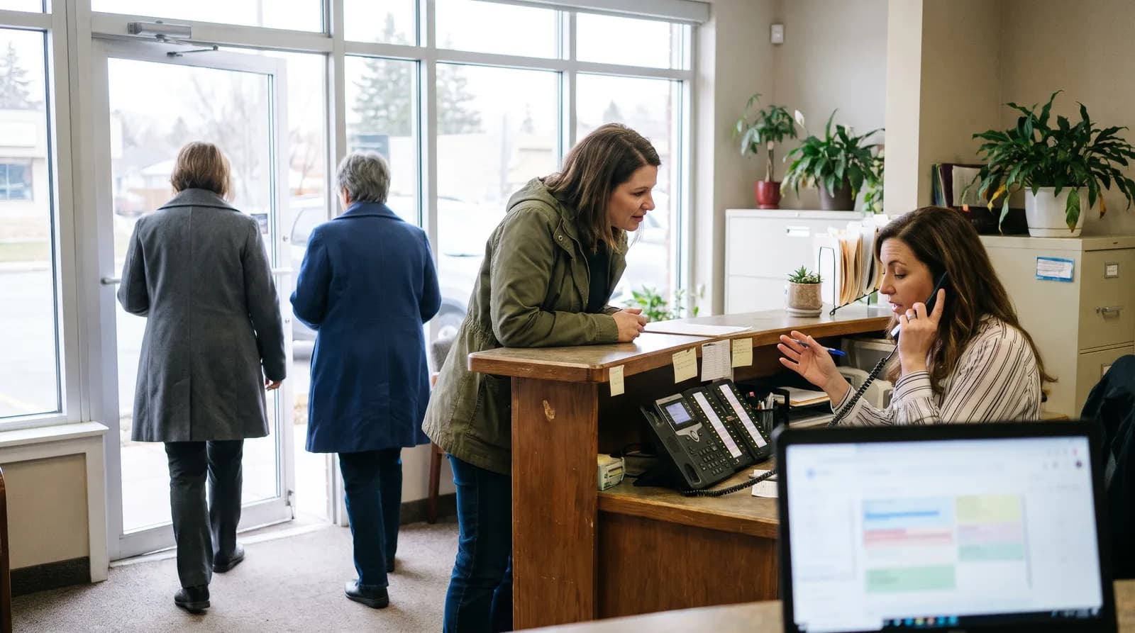 Dental office Monday morning phone calls lighting up the reception desk as patients arrive at opening time