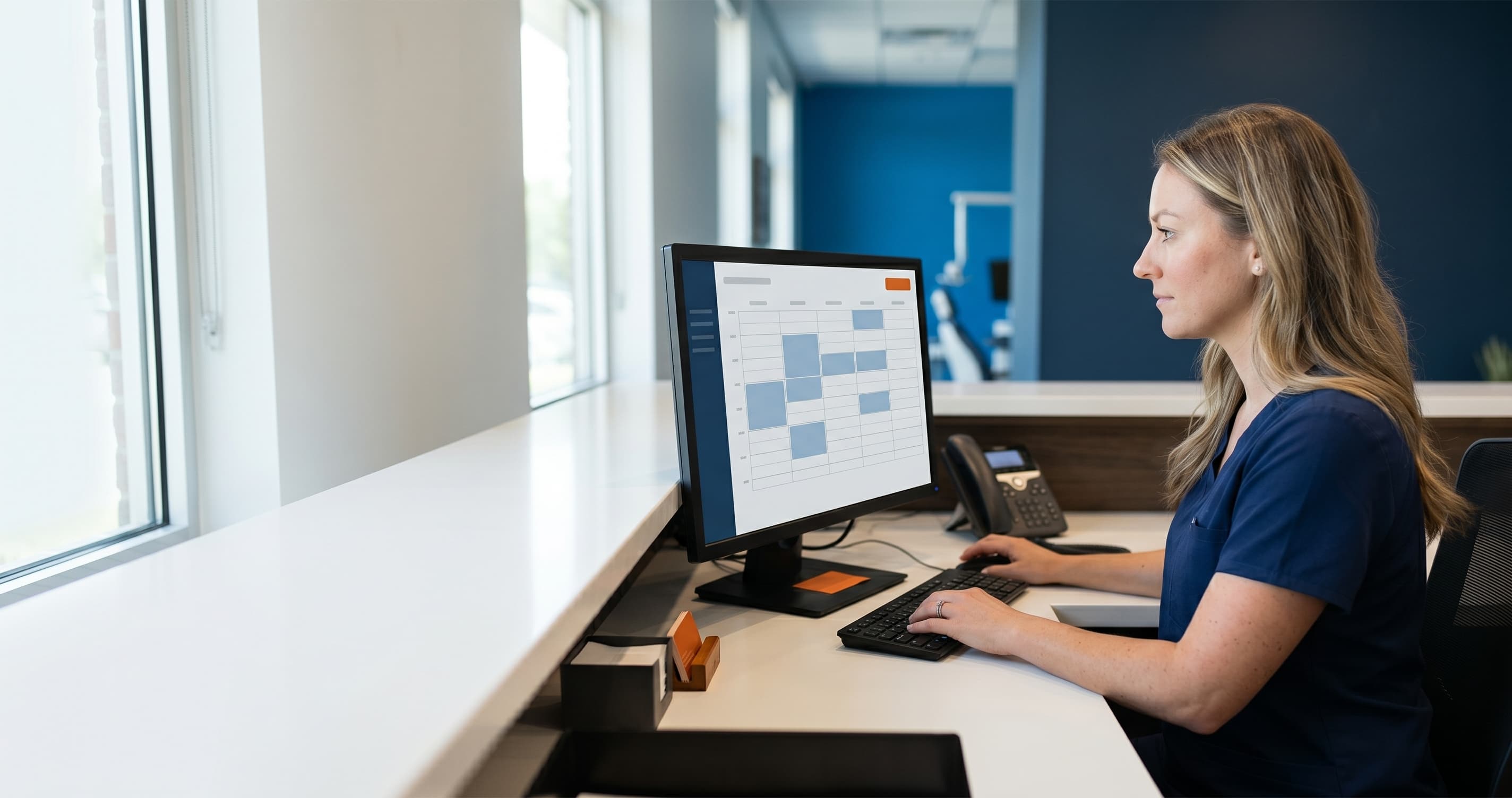 Dental office front desk where an AI receptionist interface answers calls while a hygienist assists a patient
